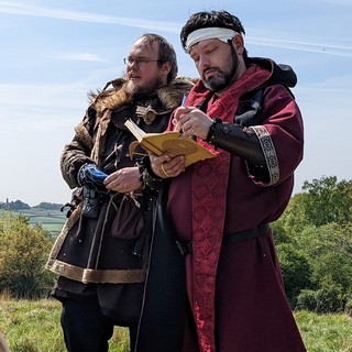A barbarian and a priest contemplate the scenery.